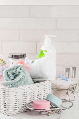 Spa relax and bath concept, sea salt, soap, with cosmetics and towels in bathroom white background, copy spaceの写真素材