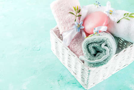 Spa relax and bath concept, sea salt, soap, with cosmetics and towels on light blue conrete background, copy spaceの写真素材