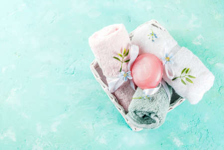 Spa relax and bath concept, sea salt, soap, with cosmetics and towels on light blue conrete background, copy spaceの写真素材