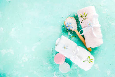 Spa relax and bath concept, sea salt, soap, with cosmetics and towels on light blue conrete background, copy spaceの写真素材