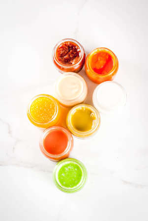 Variety of homemade baby vegetable and fruit puree,  white marble background copy space top viewの写真素材