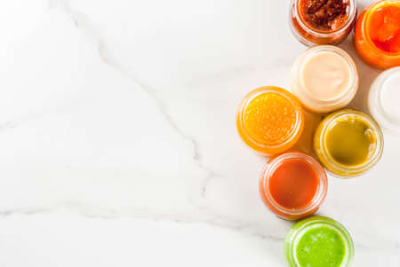 Variety of homemade baby vegetable and fruit puree,  white marble background copy space top viewの写真素材