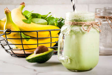 Healthy smoothie with banana and baby spinach, n white marble background copy spaceの写真素材