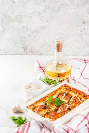 Homemade healthy diet dinner, prepared chicken turkey meatballs with sauce, cheese, greens. On a white marble table, with spices.  copy spaceの写真素材