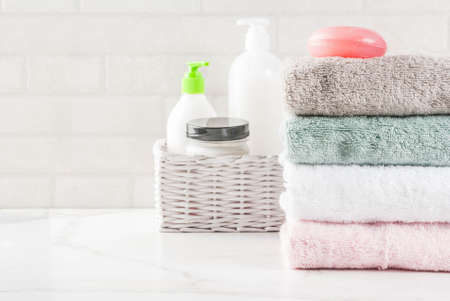 Spa relax and bath concept, sea salt, soap, with cosmetics and towels in bathroom white background, copy space top viewの写真素材
