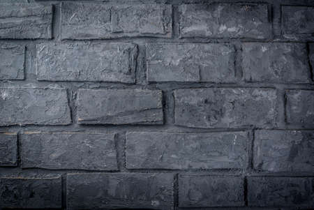 Old dark grey brick wall, background, horizontalの写真素材