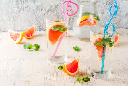 Summer refreshment detox water drink with Pink grapefruit and fresh mint, spa fruit water, lemonade...