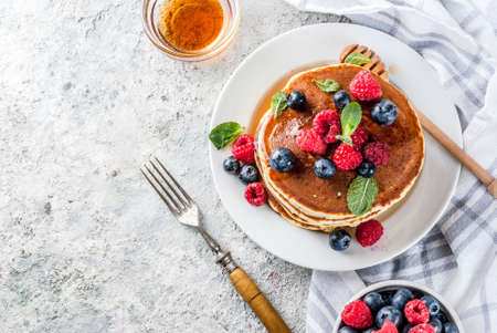 Healthy summer breakfast,homemade classic american pancakes with fresh berry and honey, morning...