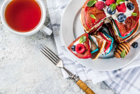 American Independence Day July 4th breakfast idea, homemade white blue red striped pancakes with...