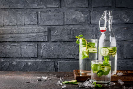Summer fresh iced drink, mint and cucumber infused water, summer healthy detox mojito cocktail,...