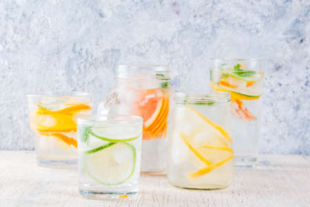 Summer healthy cocktails, set of various citrus infused waters, lemonades or mojitos, with lime lemon orange grapefruit, diet detox beverages, in different glasses light background copy spaceの写真素材