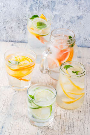 Summer healthy cocktails, set of various citrus infused waters, lemonades or mojitos, with lime...