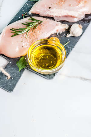 Raw chicken breast filet meat with spices and olive oil top view copy spaceの写真素材