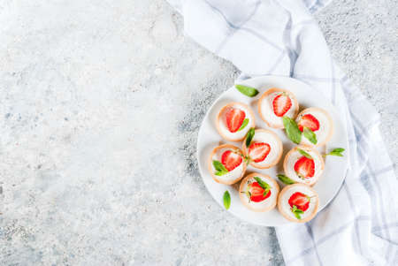 Summer sweet homemade dessert, Mini cheesecakes with strawberry on grey stone table copy space top...