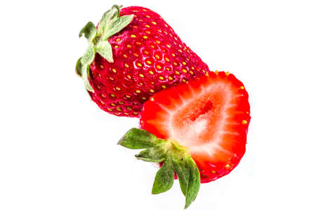 Ripe raw whole and sliced organic strawberry, isolated on white background