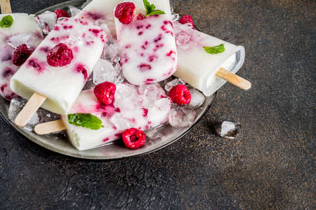 Summer sweet desserts, homemade organic ice cream popsicles from raspberry and yogurt, dark rusty...