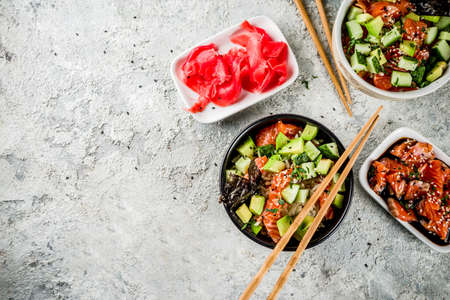 Asian trendy food, sushi poke bowl with cucumber, salmon, avocado, Black and White Sesame Seeds  