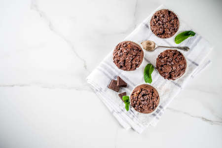 Home baked mint and chocolate muffins with mint tea, white marble background copy spaceの写真素材