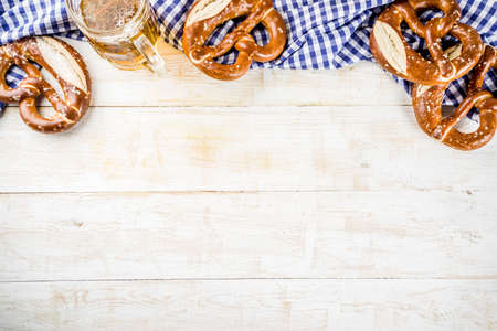 Oktoberfest food menu, bavarian pretzels with beer bottle mug, white wooden background copy space top viewの写真素材