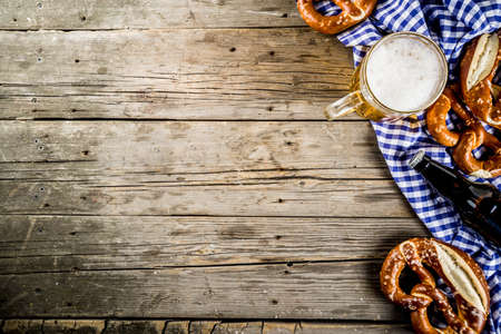 Oktoberfest food menu, bavarian pretzels with beer bottle mug on old rustic wooden background, copy space aboveの写真素材