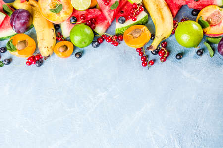 Summer vitamin food concept, various fruit and berries watermelon peach mint plum apricots blueberry...