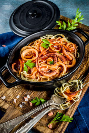 Italian cuisine, Calamari Fra Diavolo, spaghetti pasta marinara with seafood, light blue background copy space top viewの写真素材