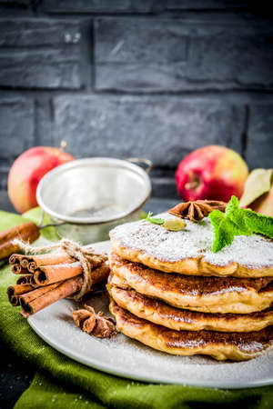 Sweet and spicy autumn apple pancakes, with anise, cinnamon and sugar, dark blue background copy spaceの写真素材