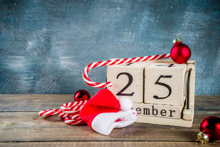 Christmas celebration concept with old retro styled wooden calendar, christmas gift and decorations,...