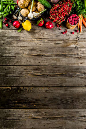 Fresh summer fruit, berry and vegetables on wooden rustic background copy space aboveの写真素材