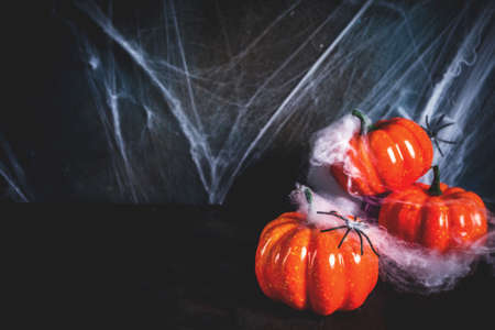 Halloween concept, a dark background old wall with cobwebs and pumpkins, greeting card backgroundの写真素材