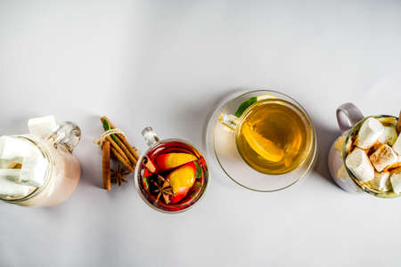 Variations winter autumn traditional drinks - pumpkin latte, hot chocolate, tea with lemon, mulled wine, copy spaceの写真素材