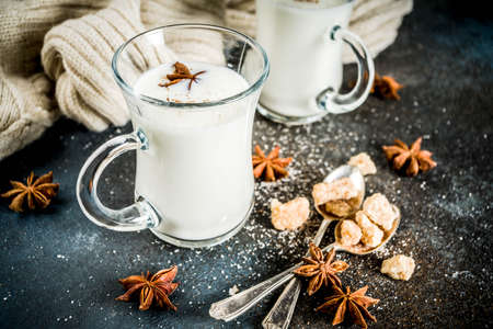 Dutch hot dairy drink Anijsmelk with milk, sugar and aniseed, dark blue rusty background copy spaceの写真素材