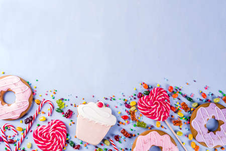 Sweets creative lay out, dessert concept with lollipops, jellies, candy, cookies donuts and...