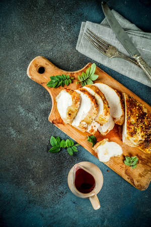 Thanksgiving holiday table with traditional festive food - turkey, pumpkin pie, pumpkins, green beans, cranberry sauce, corn, autumn apples, dark rusty table, top view space for textの写真素材