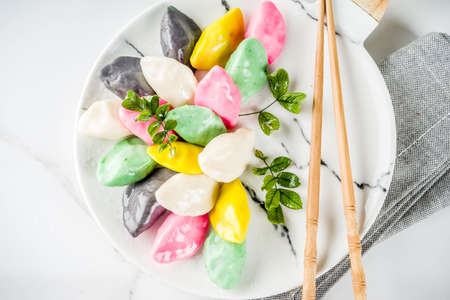 Traditional Chuseok day food, Korean Half-moon Shaped Rice Cake Songpyeon, white marble background...