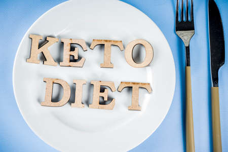 Ketogenic diet concept, healthy food background, plate, fork, knife, with Keto diet.の写真素材