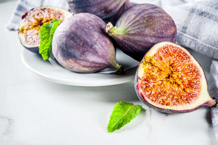 Raw fresh figs fruits on white marble background copy spaceの写真素材