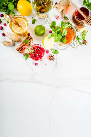 Various autumn winter herbal fruit and berry tea, with cranberry, mint, rosemary, lemon. lime. flowers, medical herbs and spices. top view copy spaceの写真素材