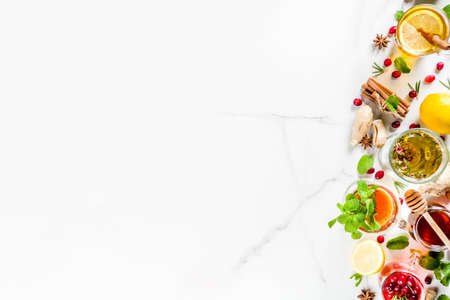 Various autumn winter herbal fruit and berry tea, with cranberry, mint, rosemary, lemon. lime. flowers, medical herbs and spices. top view copy spaceの写真素材