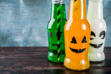 Party drinks for Halloween, three milk and juice in monster bottle, blue concrete background copy space top viewの写真素材