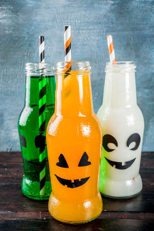 Party drinks for Halloween, three milk and juice in monster bottle, blue concrete background copy space top viewの写真素材