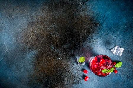 Autumn winter seasonal alcohol cocktail Cranberry vodka, dark blue background copy space top viewの写真素材