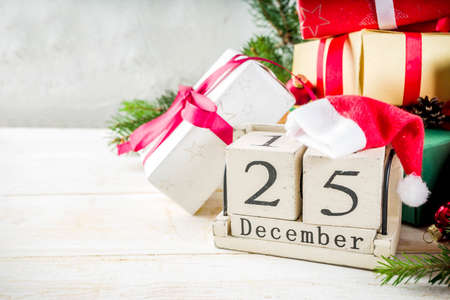 Christmas festive background with decorations and colorful gift boxes on wooden boardの写真素材