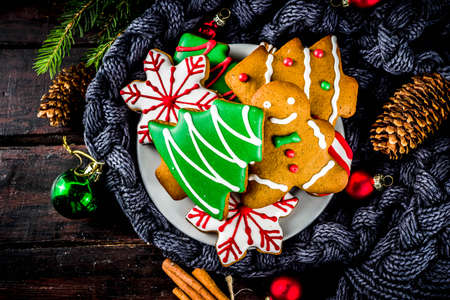 Traditional christmas sweet treats, colorful sugar glazed homemade gingerbread cookies with xmas...