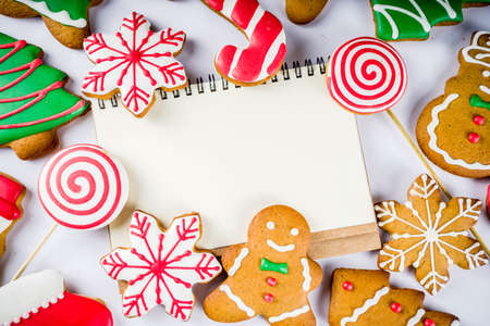 Various traditional colorful sugar glazed christmas gingerbread cookies, on white background top view copy spaceの写真素材