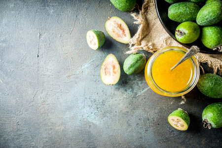Tropical fruit preserves, homemade feijoa and lime jam on a dark blue concrete background, copy spaceの写真素材