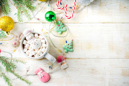 Creative idea for christmas drink, delicious hot chocolate with funny marshmallow snowman, christmas tree, rain dear, santa, on home background with xmas decoration copy space top viewの写真素材