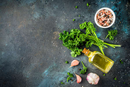 Cooking background with spices, olive oil and herbs, dark blue concrete background, copy space top viewの写真素材
