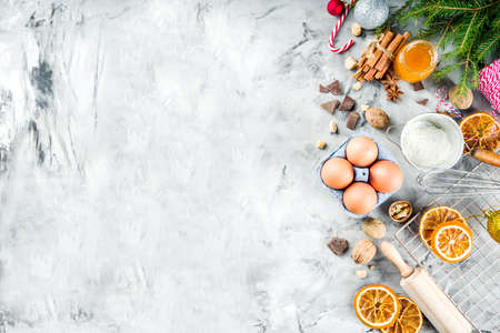 Christmas winter baking concept, ingredients for making cookies, baking, pies. Dried orange slices, spices,utensils, grey marble background copy space top viewの写真素材