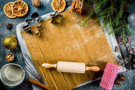 Christmas traditions homemade baking Cooking gingerbread star cookies, gingerbread men, flat lay, top view, with accessories ingredients for baking. Dark blue concrete background, copy spaceの写真素材